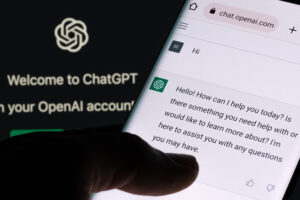 ChatGPT chat bot screen seen on smartphone and laptop display wi