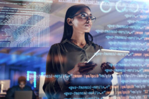Software, coding hologram and woman on tablet thinking of data analytics, digital technology and night overlay Programmer or IT person in glasses on d screen, programming and cybersecurity research