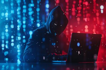 A hacker in a black hoodie with a laptop working on computer network security and cyber attack concepts, the hacker sitting at a table coding with a digital background of binary numbers and light effe