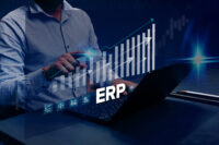 ERP Cloud System Software Automation: A businessman analyzes Enterprise Resource Planning (ERP) software or applications on a virtual screen using his laptop